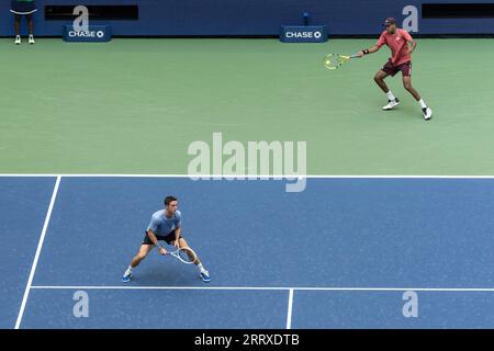 Joe Salisbury of United Kingdom and Rajeev Ram of USA in action during mens doubles final at the US Open Championships at Billie Jean King Tennis Center in New York on September 8, 2023 Stock Photo