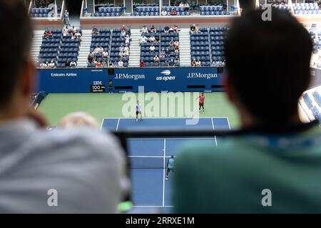 Spectators watch as Matthew Ebden of Australia and Rohan Bopanna of India play against Joe Salisbury of United Kingdom and Rajeev Ram of USA during mens doubles final at the US Open Championships at Billie Jean King Tennis Center in New York on September 8, 2023 Stock Photo