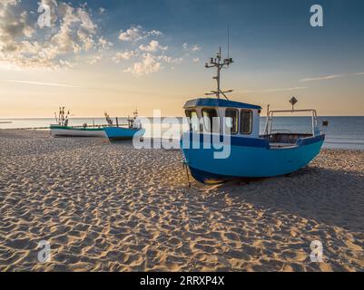 Milky way and falling stars over boats by Baltic Sea. Baltic Sea in winter at night. Stock Photo