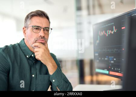 Crypto broker, financial investor, stock trader analyzing digital trading data. Stock Photo