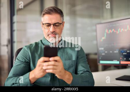 Investor trader broker analyzing financial trading stock app on cell phone. Stock Photo