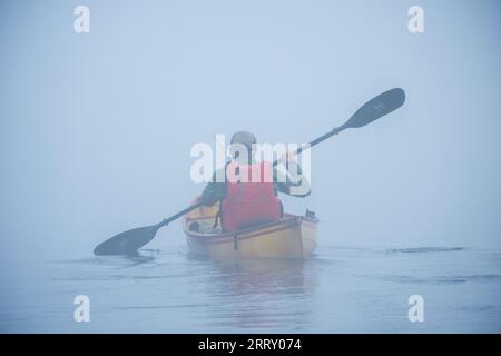 Misty Adirondack lake scene while canoeing in the Adirondack Mountains of New York State, USA, Essex Chain Lakes near Newcomb, NY, USA. Stock Photo