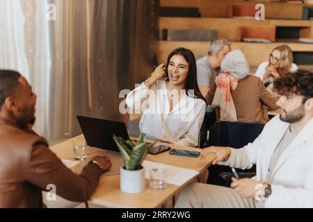 Beautiful business colleagues having fun conversation. Brunette girl laughing. Black male person telling fun experience Stock Photo