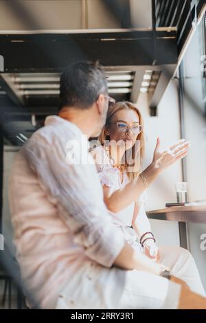 Adult professionals exchanging ideas, discussing projects, and solving problems in a diverse, successful business team in a corporate office. Stock Photo