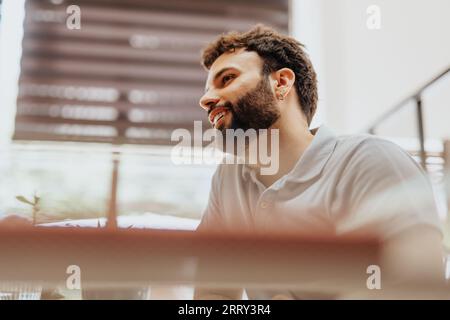 Good looking, young businessman analyzing, discussing, and collaborating in a diverse corporate office with innovative leaders and efficient teamwork. Stock Photo