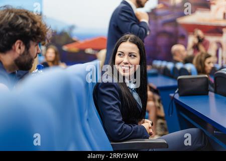 Young female student looking back at her colleague with a smile in the conference/classroom Stock Photo