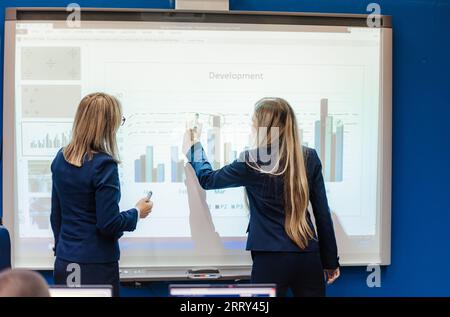 Diverse university students collaborate indoors, attending classes, discussing ideas, and sharing knowledge. They plan, study, and prepare successfull Stock Photo