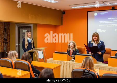 Group of students and professors getting ready to hear their student present a project Stock Photo