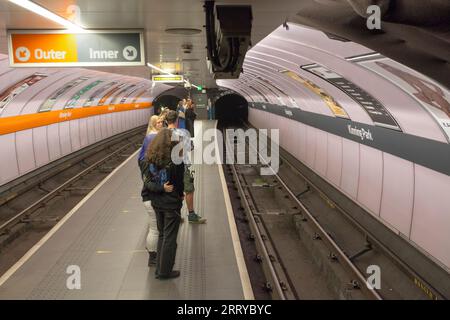 Kinning Park station on the SPT Glasgow subway showing the narrow island platform and waiting passengers Stock Photo