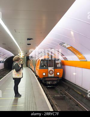 SPT subway train arriving at Glasgow Kinning Park Subway station on the Glasgow underground / subway with passengers waiting on the platform Stock Photo