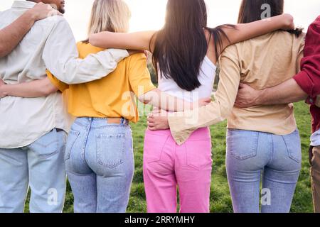 Multicultural group as team and community side by side in nature. Unrecognizable friends together. Stock Photo