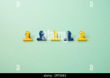 Paper binder clip isolated on green background. top view Stock Photo