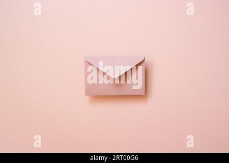 Envelope isolated on pink background. top view, copy space Stock Photo