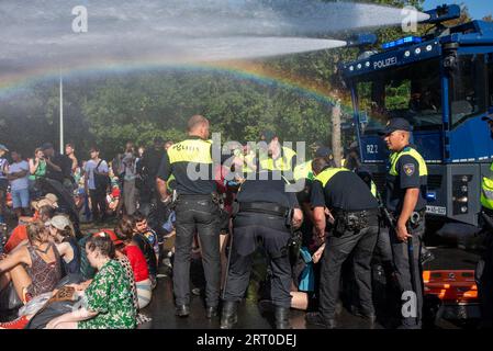 The Hague, Netherlands. 09th Sep, 2023. While the police deploys the water cannon and the rainbow appears over the head of the protesters, the police officers start the arresting as well during the demonstration. Thousands of Extinction Rebellion climate activists blocked the A12 motorway in The Hague, Netherlands. They try to pressure the government to stop investing immediately into fossil fuels because of the climate change. (Photo by Krisztian Elek/SOPA Images/Sipa USA) Credit: Sipa USA/Alamy Live News Stock Photo