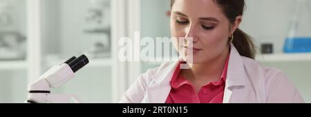 Female scientist taking notes while reviewing results of scientific experiments in laboratory. Stock Photo