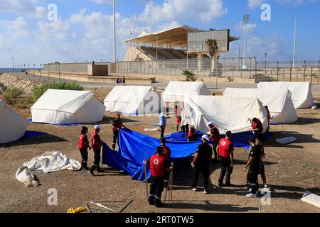 (230910) -- BEIRUT, Sept. 10, 2023 (Xinhua) -- Volunteers from the Lebanese Red Cross set up tents for Palestinians displaced from Ain Al-Helweh camp in Sidon, south Lebanon, Sept. 9, 2023. Armed clashes between members of the Fatah Movement and Islamic militants in Ain Al-Helweh Palestinian refugee camp in southern Lebanon intensified on Saturday, killing two people and injuring 11 others, the National News Agency reported. The clashes led to a new wave of displacement from the camp, as hundreds of families took refuge in the hall of the Mosuli Mosque in the city of Sidon. (Photo by Ali Has Stock Photo