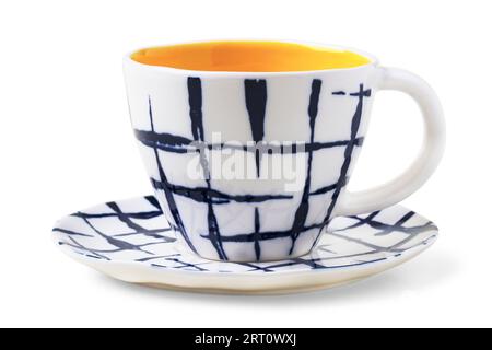 Checkered ceramic tea cup and saucer isolated on white background Stock Photo