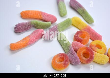 Beautiful and bright colored sweets of children's candies in the form of sweet earthworms of different colors, American donuts, lollipops. Stock Photo