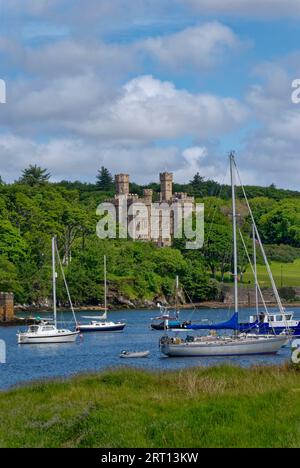 Yachts moored in the calm waters of the Estuary at Stornoway harbour, with Lews castle in the background on a sunny day. Stock Photo