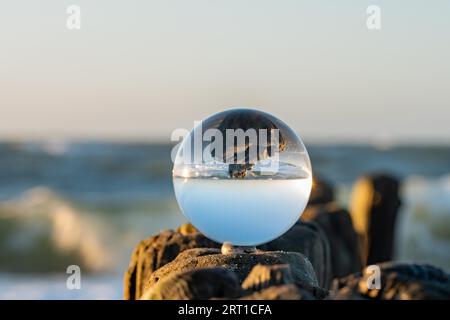 Glass ball photography on a groyne Stock Photo