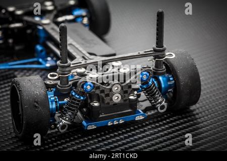 RC car chassis and parts being assembled to form a radio controlled race car Stock Photo