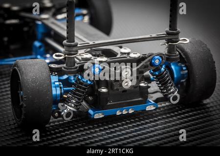 RC car chassis and parts being assembled to form a radio controlled race car Stock Photo