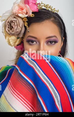 Mexican woman with flower headdress holding a mexican passport. Woman