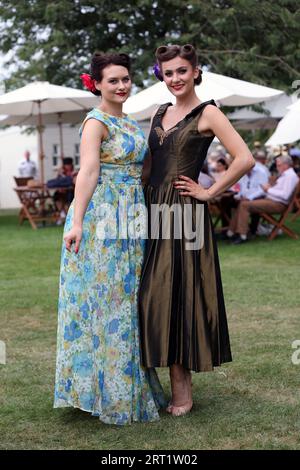 Visitors pose in vintage fashion at the Goodwood Revival at the Goodwood Motor Circuit in West Sussex. Picture date: Sunday September 10, 2023. Stock Photo