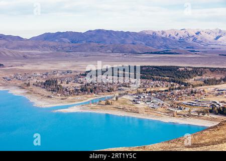 The view over the town of Tekapo from Mt John Walkway and observatory area near Lake Tekapo on a clear spring evening in New Zealand Stock Photo