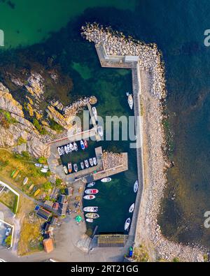 Bornholm, Denmark, August 09, 2020: Top down drone view of anchored boats in the small port of Sandvig Stock Photo