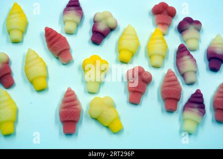 Beautiful and bright photos of sweets, candies. Jelly colored candies in the form of cakes, ice cream, yummy treats arranged on a white background. Stock Photo