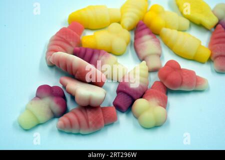 Beautiful and bright photos of sweets, candies. Jelly colored candies in the form of cakes, ice cream, yummy treats arranged on a white background. Stock Photo