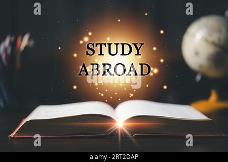 STUDY ABROAD inscription coming out from an open book, educational concept. Back to School. Education in Global world, Study abroad business in univer Stock Photo