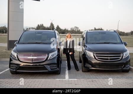 Portrait of business woman near a luxury cars outdoors Stock Photo