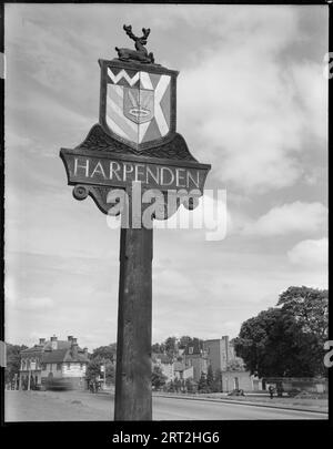 Village Sign, St Albans Road, Harpenden, St Albans, Hertfordshire, 1945-1960. View of the village sign from the south, with the Railway Hotel in the background. Stock Photo