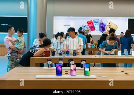 CHONGQING, CHINA - SEPTEMBER 10, 2023 - People experience Apple products at an Apple store on Jiefangbei Pedestrian Street in Chongqing, China, Sept. Stock Photo