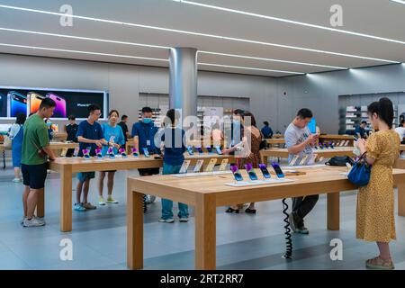 CHONGQING, CHINA - SEPTEMBER 10, 2023 - People experience Apple products at an Apple store on Jiefangbei Pedestrian Street in Chongqing, China, Sept. Stock Photo