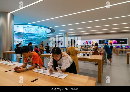 CHONGQING, CHINA - SEPTEMBER 10, 2023 - People experience Apple products at an Apple store on Jiefangbei Pedestrian Street in Chongqing, China, Sept. Stock Photo