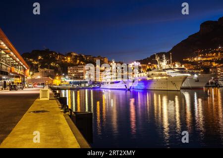 Monaco principality at night, luxury yachts at Port Hercules waterfront Stock Photo