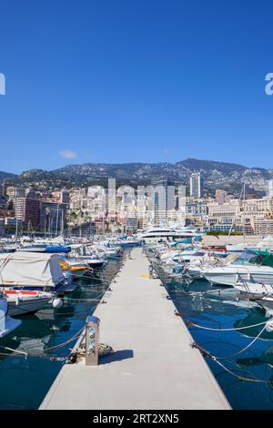 Monaco principality cityscape, pier with boats and yachts at Port Hercule on Mediterranean Sea, view to Monte Carlo Stock Photo