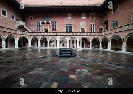 Collegium Maius arcade courtyard with well in city of Krakow in Poland, oldest building of Jagiellonian University, 15th century late Gothic Stock Photo