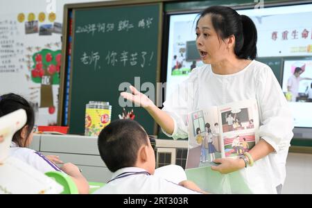 (230910) -- HAIKOU, Sept. 10, 2023 (Xinhua) -- Fu Yaohui gives a class at Hainan (Haikou) Special School in Haikou, south China's Hainan Province, Sept. 5, 2023. Fu Yaohui is a teacher at the special education school in Haikou. Since 2004, Fu has been engaged in special education for students with intellectual disabilities, cultivating their basic skills to adapt to life. Every day, Fu arrives at school early and accompanies the students with patience and encouragement. 'I want my students to be self-reliant,' she said. In order to achieve this goal, she tries her best to help these children Stock Photo