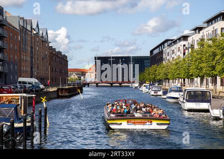 Copenhagen, Denmark, August 21, 2019: Tourist boat in a canal in Christianshavn district Stock Photo