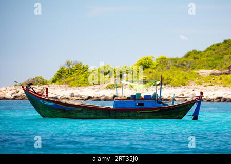 A fishing boat is anchored off the coast near Nha Trang in Vietnam Stock Photo