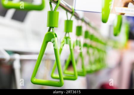 The handles in a train on the JR Yanamoto Line in Tokyo, Japan Stock Photo