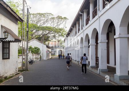 Galle Fort, Sri Lanka, July 28, 2018: People in a small cozy street in historical Galle Fort Stock Photo