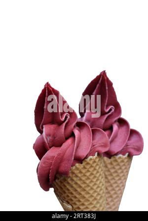 A waffle ice cream cone filled with a delicious freshly made raspberry soft ice cream Stock Photo