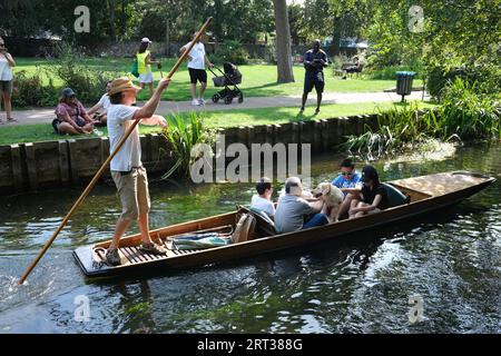 Punting on the River Stour in Canterbury, Kent, Uk.  People enjoying Englands Indian summer tourists enjoy the shade on the river stour in the Westgate towers, Canterbury, Kent, UK. Credit: DAVE BAGNALL Stock Photo