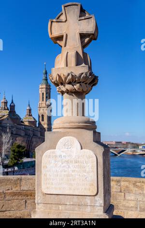Zaragoza, Spain - February 14, 2022: Cross commemorating Basilio Boggiero over the Puente de Piedra on the Ebro River in Zaragoza. Stock Photo