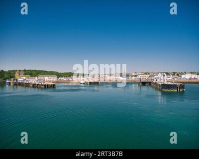 A panorama of Stornoway harbour on the Isle of Lewis in the Outer Hebrides in Scotland, UK. Taken on a calm, sunny day in summer from the departing fe Stock Photo